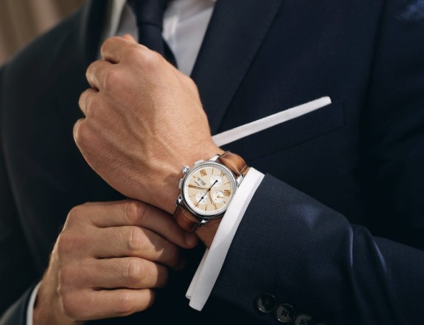 Watch, Suit, Wrist, Analog watch, Hand, Formal wear, Tuxedo, Fashion accessory, Finger, Gesture, 