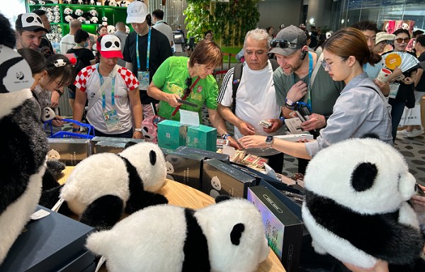 熊猫基地的商店里，外国游客正在选购熊猫周边。（时代周报 王晨婷/摄）