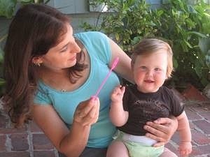 Mayim Bialik blows bubbles with her son.