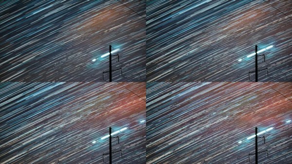 电力线上方的星星踪迹。4k延时夜星空。夜空背景上的星星轨迹。大曝光。天空中惊人的星星效果。星星在天空