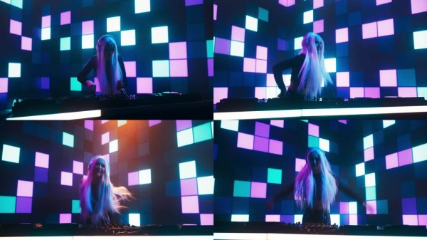 女性舞蹈音乐艺术家在夜总会的舞台上表演DJ，站在唱机转盘后面，在霓虹音乐会的背景下，有电影般的黑暗灯