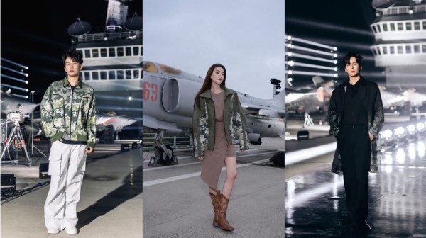 a group of people standing in front of a plane