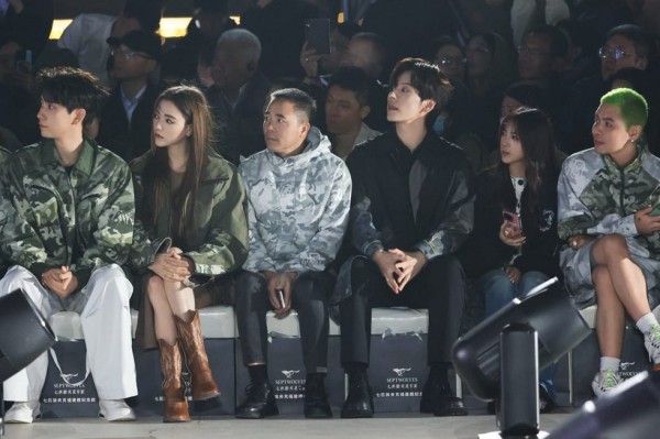 a group of people sitting on a stage