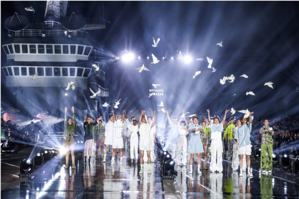 a group of people in white suits