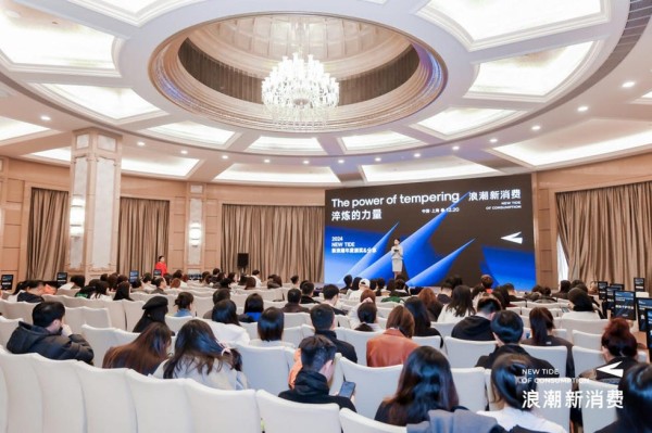 conference or presentation event featuring a speaker and audience in a formal setting