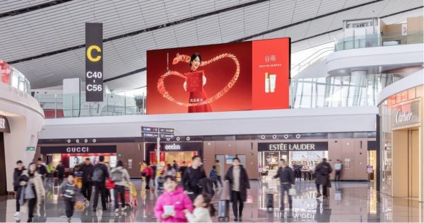interior of an airport terminal with shops and an advertisement display
