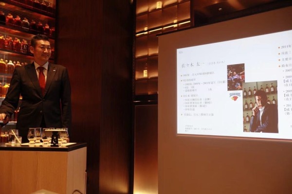 a man standing in front of a screen