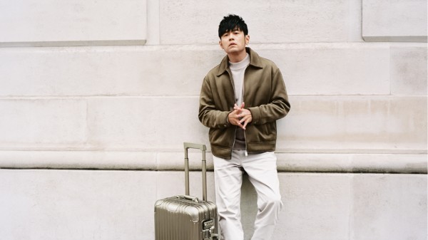a man standing next to a suitcase