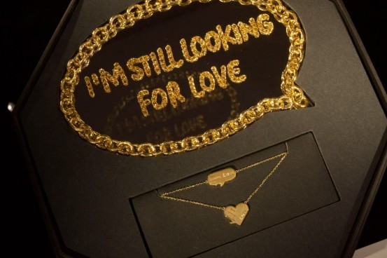gold jewelry display featuring a chain and a heart pendant
