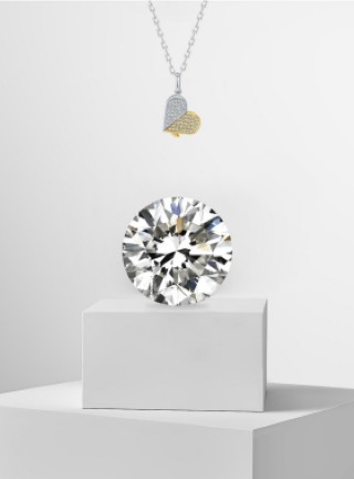 jewelry display featuring a diamond and a heartshaped pendant
