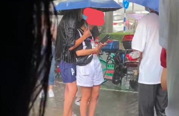 情侣做核酸突降大雨，男子浑身湿透替女友撑伞，女友却低头玩手机