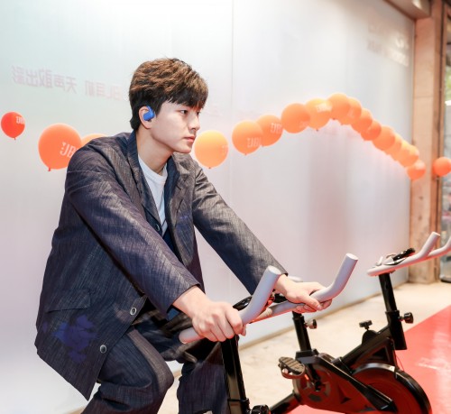 person exercising on a stationary bike in a branded environment