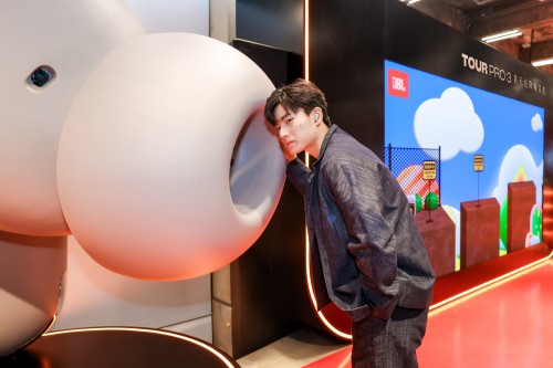 interaction with a large cartoonish object in a promotional space featuring a multimedia display