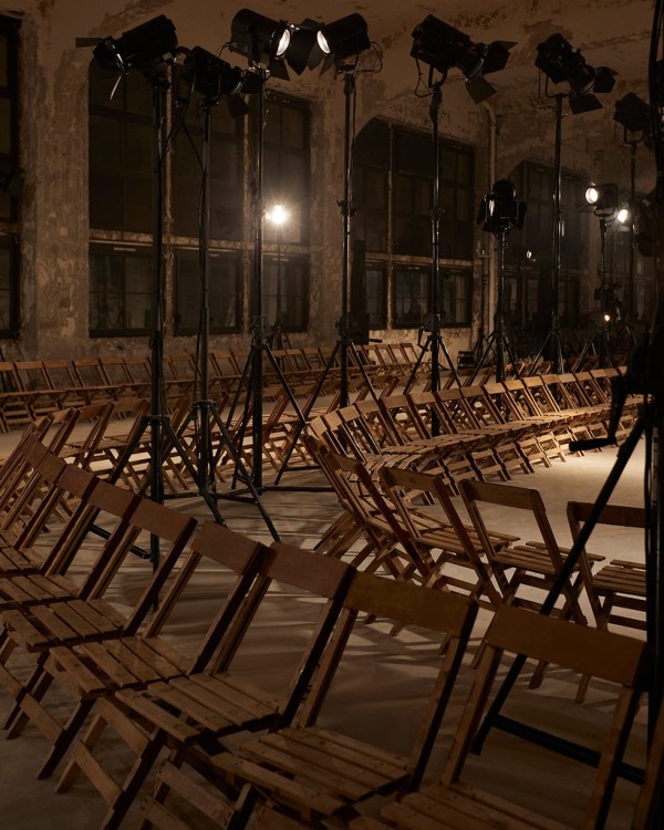 seating arrangement for a fashion show with spotlights in an industrial space