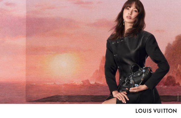 fashion advertisement featuring a model in a black dress holding a designer handbag